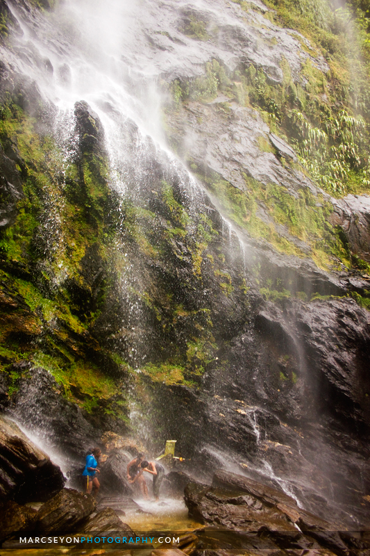 Photo walkers at play under the Maracas Waterfall, Marc Seyon